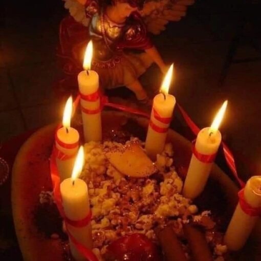 Candlelit altar with angel statue and offerings of a binding spell