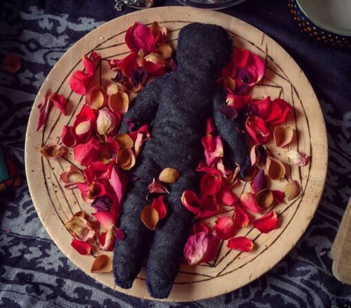 self-love spells Black fabric doll surrounded by rose petals on a wooden platter